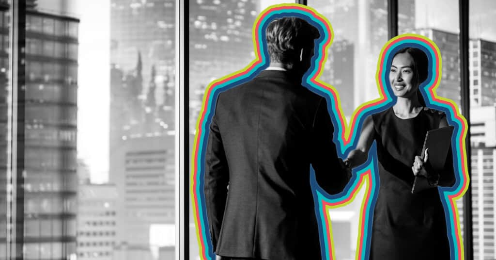 A smiling female professional shaking a customers hand.