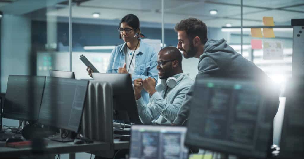 A diverse team of tech workers discovering the history of marketing automation.