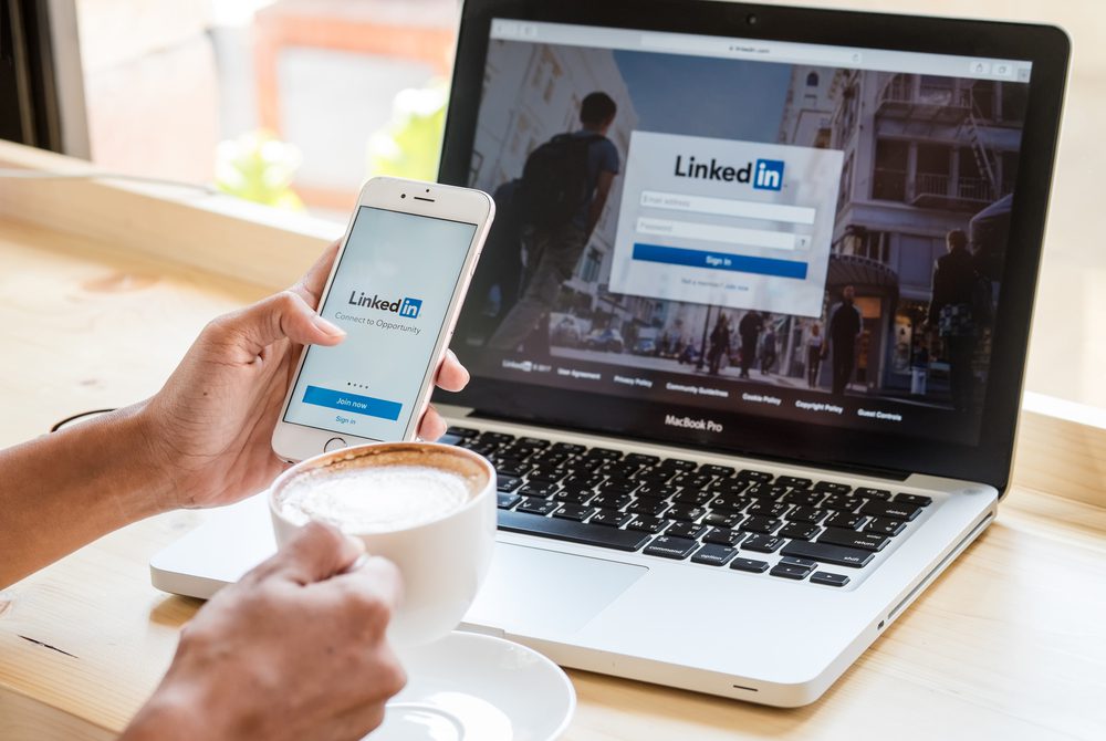 A user logs in to write content for LinkedIn on a laptop and mobile device.