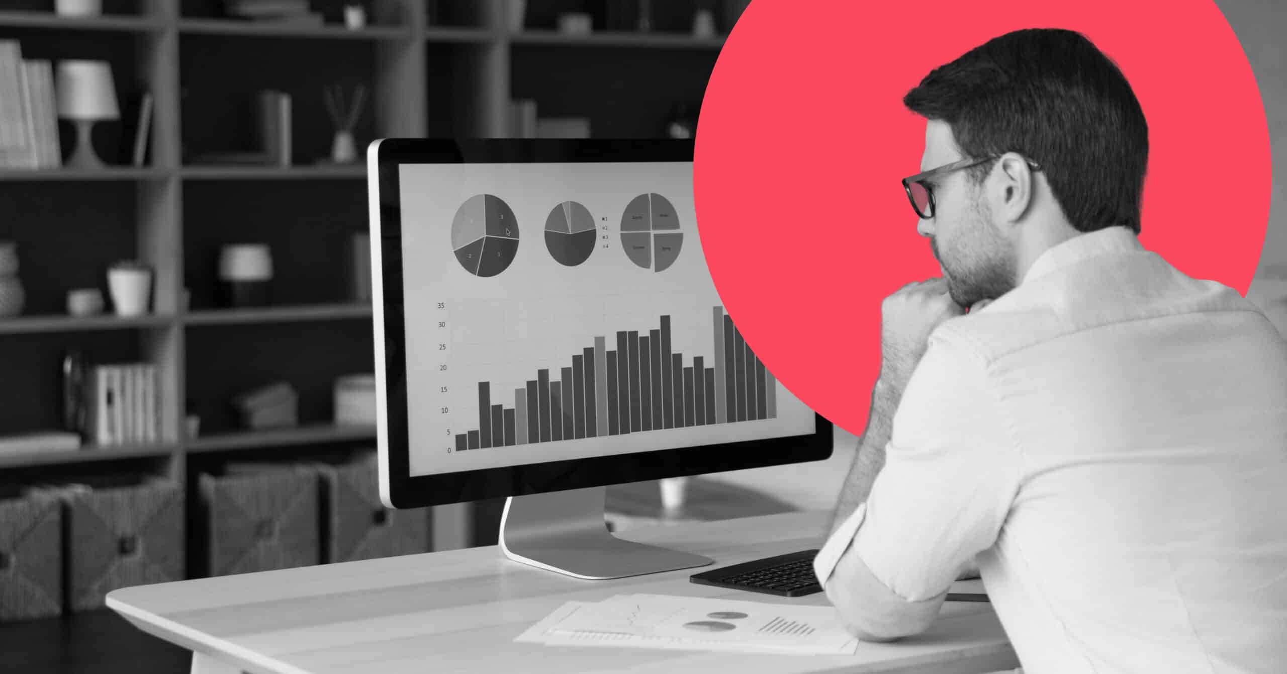An individual uses a desktop computer to compare Marketo vs Pardot.