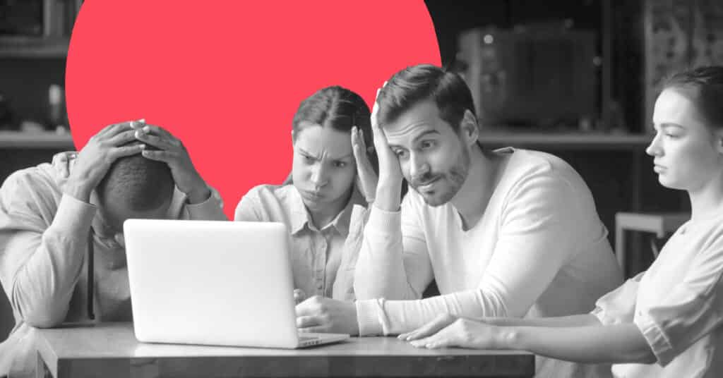 a frustrated team gathered around a laptop computer considering marketing automation migration