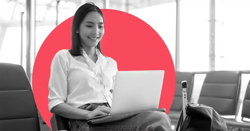 A woman at an airport lounge gets some work done on her laptop.