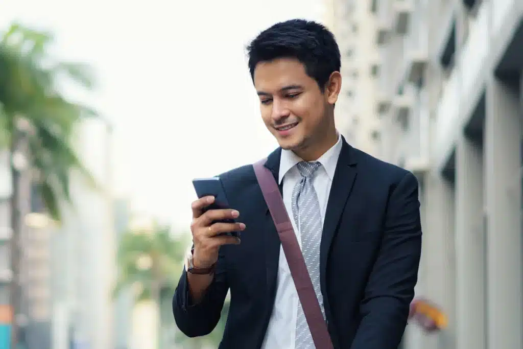Man using insurance marketing automation while walking.