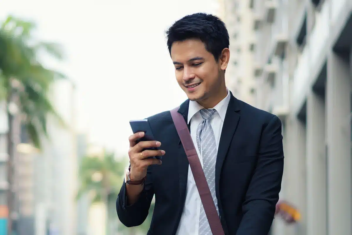 Man using insurance marketing automation while walking.